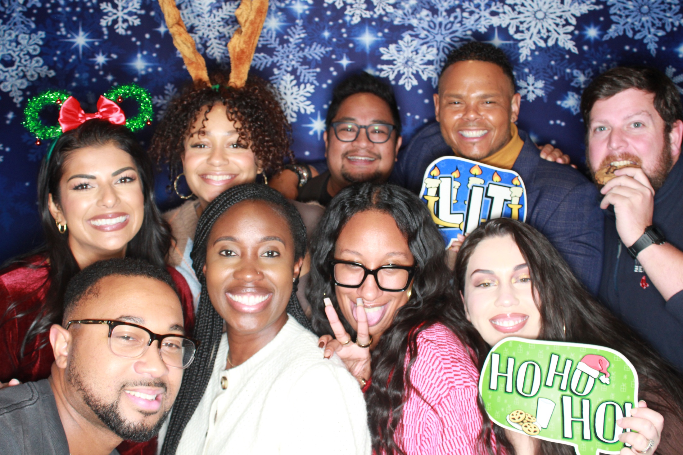 Coworkers laughing together with holiday props at the FOX5 company party