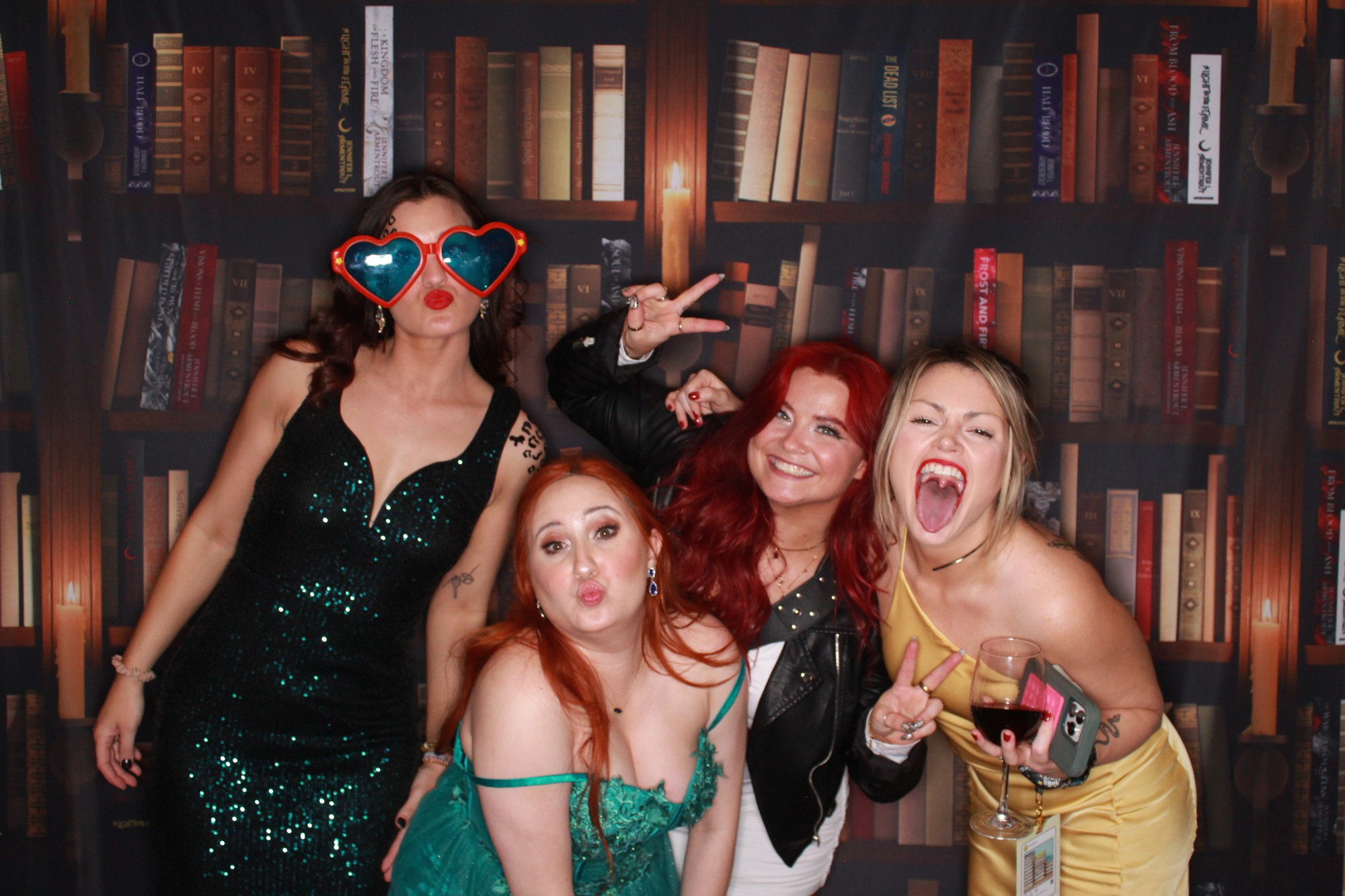 ApollyCon guests enjoying the custom bookcase backdrop
