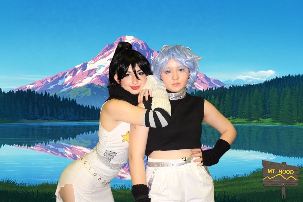 Katsucon guests posing in front of a scenic digital background